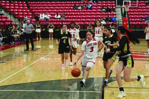Brownfield’s Lucy Guzman (3) drives past a pair of Lamesa defenders during a District 3-3A game on Friday at The Pit in Brownfield. (Photos by Lee Scheide | Brownfield News)