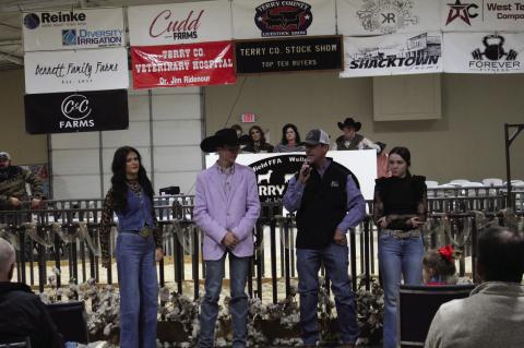 Kate Smith (left), Ryder Day (second from left) and Rayleigh Perry (right) listen to Terry County Vet Dr. Jim Ridenour talk about the Charles Orum Scholarship program during the Terry County Livestock Show on Saturday at the Terry County Show Barn.