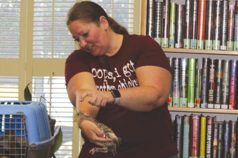 Kira Nelson holds a chick as she talks to youth at the Library. (Photo by Lupe Perez)