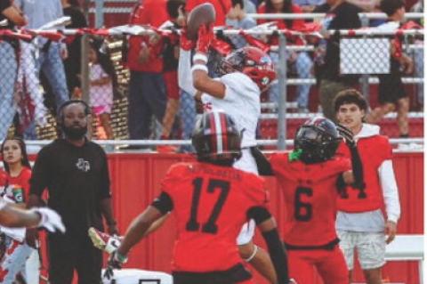 Brownfield’s Ace Martinez leaps for an interception as Levelland wide receiver Eric Paredez (6) during a nondistrict game on Friday at Levelland.
