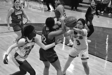 Caylee Stell, left, and Lucy Guzman attempt to steal the basketball from a Monahans player Monday during a game at home. (Melissa McCaghren/Brownfield News)