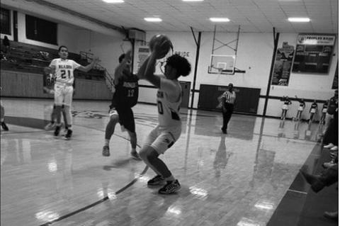 Meadow’s Isaac Estrada (20) takes a shot as Amherst’s Aiden Rodriguez (12) defends during a District 5-1A game on Friday at Meadow High School.