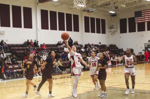 Brownfield’s Lucy Guzman splits a pair of Kermit defenders for a layup during a Class 3A Division I bi-district playoff game on Monday at Klondike High School.