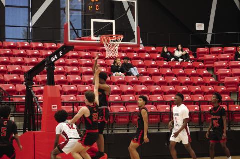 Brownfield’s Jeron Lawrence (12) gets Lubbock Coronado’s CJ Mitchell (11) to leave his feet while attempting a layup during a nondistrict game on Tuesday at Brownfield. (LEE SCHEIDE|BROWNFIELD NEWS)