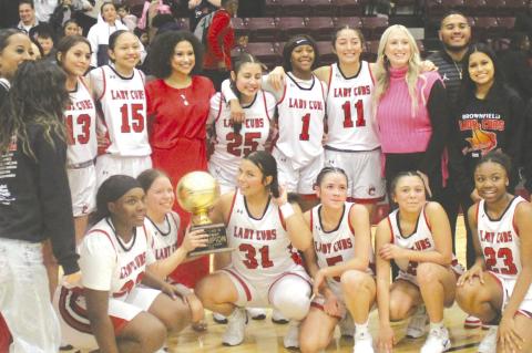 The Brownfield girl’s basketball team poses with the Class 3A Division I bi-district trophy after defeating Kermit, 59-36, on Monday at Klondike High School. The Lady Cubs were scheduled to play Shallowater in the area round on Thursday at South Plains 