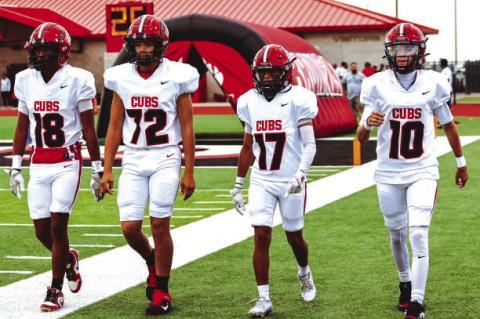 BrownfieldcaptainsJaridenValderas(18),MikeRodriguez(72),JaythanStell(17)andBraylonBruno (10) head to the field for the pregame coin toss against Levelland on Friday in Levelland.
