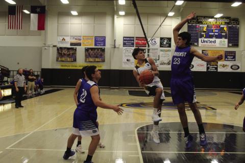 Wellman-Union’s Eli DePoyster (1) concentrates on the basket as Amherst’s Joel Garcia (23) attempts to block the shot in a District 5-1A game on Friday at Wellman-Union High School. (Photos by Lee Scheide | Brownfield News)