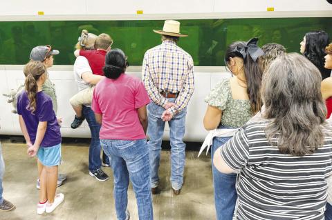 	Guests watch as a laser cutter makes an equipment part at SM Fab Thursday morning during the annual Terry County Farm Tour
