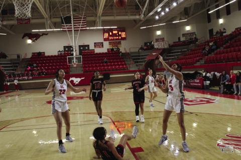 Brownfield’s Mariah Perez (11) hits the court after taking a charge from Denver City’s Hayley Garcia (3) during a District 3-3A game on Tuesday at Dag Azam Gymnasium in Denver City.
