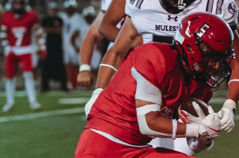 Brownfield running back Asiel Morin (5) lowers his shoulder to gain some extra yardage against Muleshoe on Friday in Muleshoe.