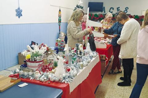 ift enthusiasts look at a variety of items from vendors at the Arnold Community Educational Services building Thursday evening during the 12th annual Keep the Cheer Here. (Lupe Perez/Brownfi eld News)