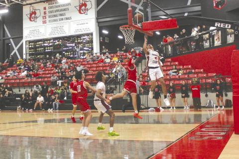 Brownfield’s Quavience Busby (4) scores as Denver City’s Gunner Bradley (5) defends during a District 3-3A game in December at The Pit in Brownfield. (Lee Scheide | Brownfield News)