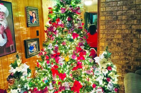 A Christmas tree decorated with Santa Claus and other ornaments adorns the living room of the Duke and Karyn Bynum House Tuesday evening during the Home for the Holidays Tour. It was one of three houses on the tour, along with the Terry County Heritage Mu