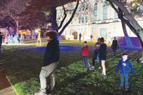 Residents and guests enjoy Christmas decorations and visiting after the annual Christmas Light Parade Monday evening. They could also purchase food at one of several food trucks.