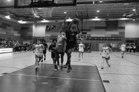 Brownfield’s Quavience Busby (4) drives for a layup as Compass Academy’s Ryker Henderson (1) defends during a District 3-3A game on Dec. 20 at Compass Academy in Odessa. (Photos by Lee Scheide | Brownfield News)