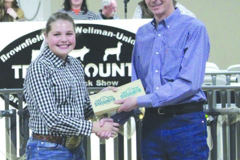 Landri Furgeson of Meadow gets her buckles after earning Grand Champion and Reserve Grand Champion honors in the Lamb Division at the 2025 Terry County Livestock Show on Jan. 11 at the Terry County Show Barn.